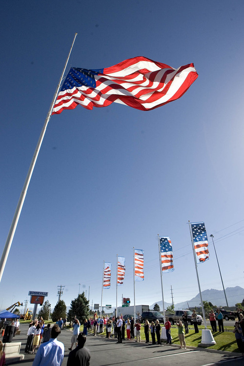 Paul Fraughton  |  The Salt Lake Tribune
To commemorate Flag Day, Colonial Flag in Sandy raised its 30-by-60 American flag after a brief ceremony. The Challenger School's corporate headquarters, across the street from Colonial, raised an identical flag at the same time.