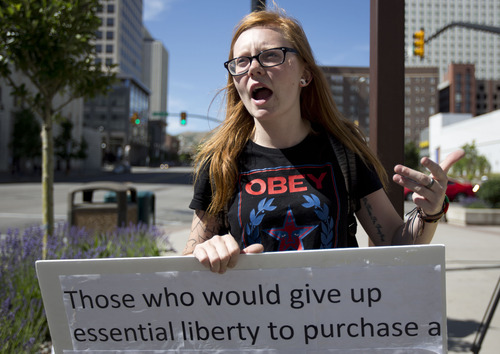 Lennie Mahler  |  The Salt Lake Tribune
Macey Booth speaks out against PRISM, an NSA program which gathers and stores phone and internet data without user permission. The protest attracted six people in front of the Wallace Bennett Federal Building in Salt Lake City, Friday, June 14, 2013.