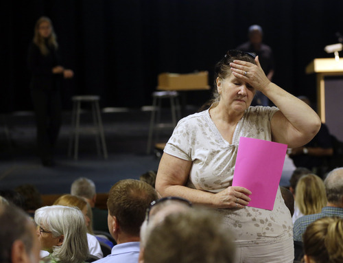 Judy Scott, of Black Forest, Colo. waits for an informational meeting for residents affected by the Black Forest Fire at Palmer Ridge High School in Monument, Colo. on Saturday, June 15, 2013. Scott's home was partially damaged by the fire. (AP Photo/Marcio Jose Sanchez)