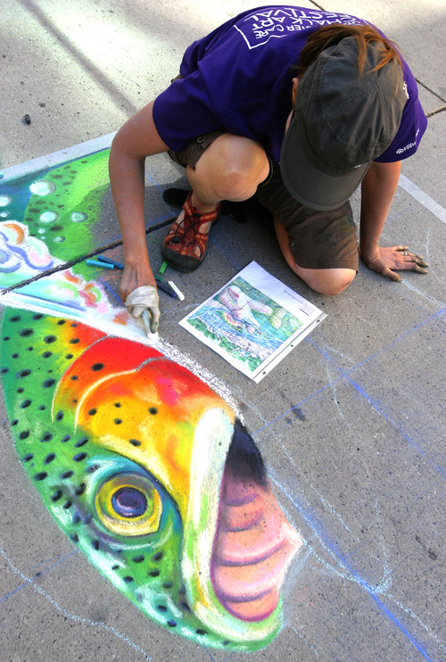 Rick Egan  |  The Salt Lake Tribune 
Rebecca Haacke works on a chalk drawing, Friday, June 14, 2013. More than 140 chalk artists created works of art on the pavement at The Gateway Friday.