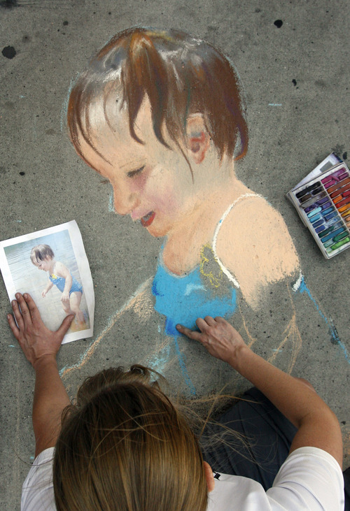 Rick Egan  |  The Salt Lake Tribune 
Mary E. Jensen draws a picture of her niece at the Utah Foster Care Foundation's Annual Chalk Art Festival, at The Gateway in Salt Lake City, Friday, June 15, 2012.  The festival continues through Saturday.