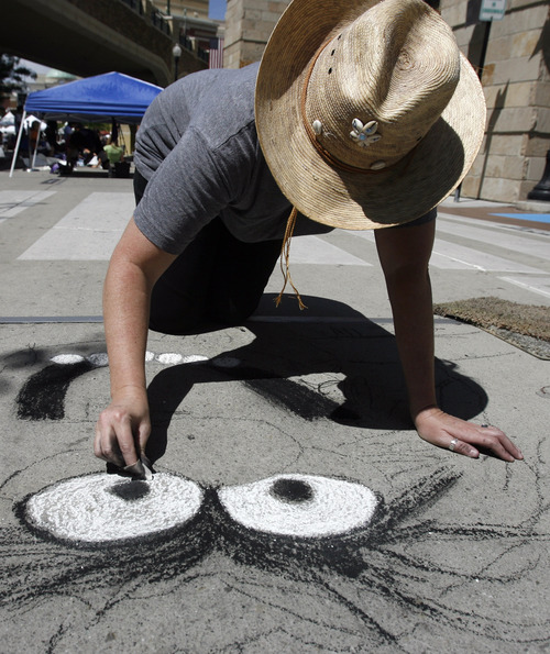 Rick Egan  |  The Salt Lake Tribune 
Kris Herschbeck draws "Animal" at the Utah Foster Care Foundation's Annual Chalk Art Festival, at The Gateway in Salt Lake City, Friday, June 15, 2012.  The festival continues through Saturday.
