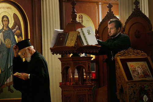 Scott Sommerdorf   |  The Salt Lake Tribune
Aaron Gilbert, right, during a service on Sunday, June 9, 2013, plans to follow his father, Father Matthew Gilbert, of Salt Lake City's Holy Trinity Greek Orthodox Church, into the priesthood. Father George Politis is at left.