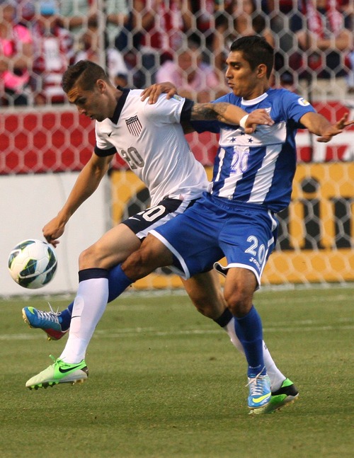 Leah Hogsten  |  The Salt Lake Tribune
Geoff Cameron (20) of the U.S.  and Honduras' Jorge Claros (20). USA defeated Honduras 1-0 at the half during their World Cup soccer qualifying rematch Tuesday, June 18, 2013 at Rio Tinto Stadium.