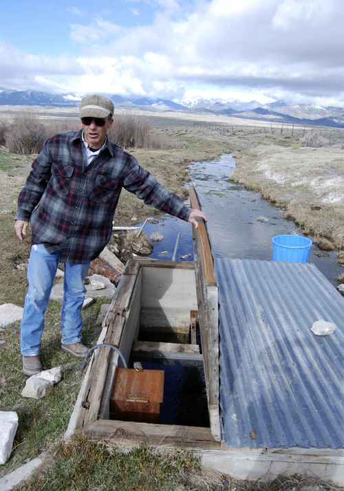 Brian Maffly | The Salt Lake Tribune

Dave Baker examines a monitoring station on a tiny spring that feeds his family's sprawling Snake Valley ranch. Data from this and dozens of other monitors is intended to guide controversial groundwater development proposed by Las Vegas.