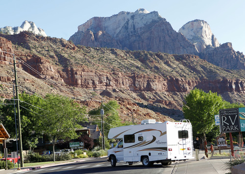 Al Hartmann  |  Tribune file photo

An RV turns onto Zion Park Blvd. in Springdale to enter Zion National Park in June 2012. Two officials have been charged after a state audit said Springdale police illegally collected money from foreign tourists and that some of the cash was not accounted for.