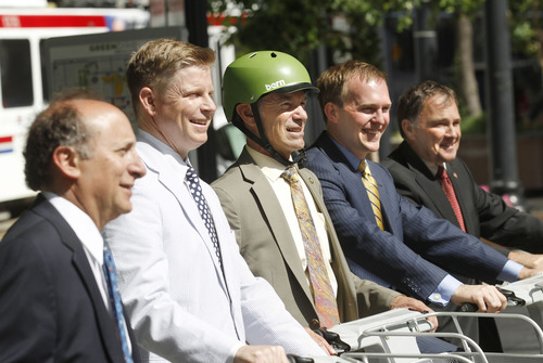 Al Hartmann  |  The Salt Lake Tribune
UTA General Manager Mike Allegra, left,  Jonathan Johnson, chairman of the Salt Lake Chamber of Commerce's Clean Air Task Force, Salt Lake City Mayor Ralph Becker, Salt Lake County Mayor Ben McAdams, and Utah Governor Gary Herbert, pose on green bikes following a press conference in downtown Salt Lake City Wednesday June 19 to issue the fifth annual Clear the Air Challenge to encourage Utahns to reduce air pollution by driving less and using mass transit more.