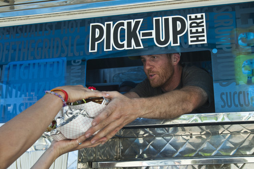 Chris Detrick  |  The Salt Lake Tribune
Vinny Mannello gives a customer their order in Off the Grid's food truck parked near 200 South and 200 West Wednesday June 5, 2013.