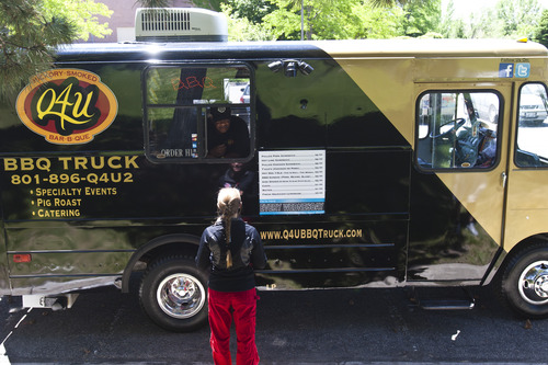 Chris Detrick  |  The Salt Lake Tribune
Tommy T. Brown takes an order at his Q4U barbecue truck Wednesday June 5, 2013.