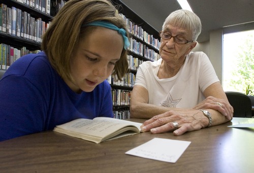 Paul Fraughton  |  The Salt Lake Tribune
Nadeen Leishman helps Brylee Robinson with her reading. Nadeen is a volunteer participating in a program at the Weber County Library tutoring youngsters who need help with reading skills.  Tuesday, June 18, 2013