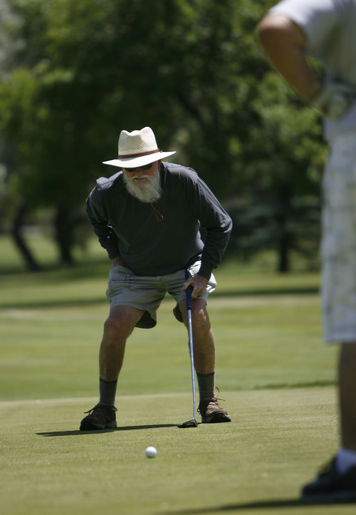Francisco Kjolseth  |  The Salt Lake Tribune
Kenton Dale of Holladay lines up his final putt during a regular round with friends at the Mick Riley Golf Course in Murray on Wednesday, June 19, 2013. The golf course popular with kids and seniors could be facing closure because the Salt Lake City Water Department, which owns most of the property, is increasing the rent to reflect the value of the land, needing that revenue to fund its operations. The county, which operates the course, has negotiated a five-year lease with the city to try to find a permanent solution -- including possible closure.