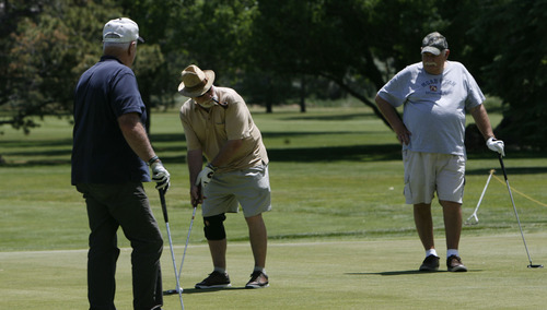 Francisco Kjolseth  |  The Salt Lake Tribune
Jerrold Webb, Julius Nuckolas and Gary Swanson, from left, fnish up a round of golf at the Mick Riley Golf Course in Murray on Wednesday, June 19, 2013. The golf course popular with kids and seniors could be facing closure because the Salt Lake City Water Department, which owns most of the property, is increasing the rent to reflect the value of the land, needing that revenue to fund its operations. The county, which operates the course, has negotiated a five-year lease with the city to try to find a permanent solution -- including possible closure.