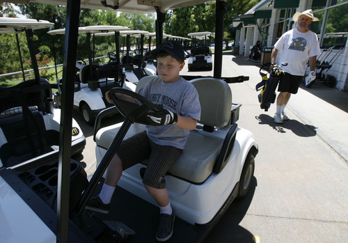 Francisco Kjolseth  |  The Salt Lake Tribune
Nathan Johnson, 9, gets his chance to drive as he and his dad Ray of Salt Lake City visit Mick Riley Golf Course in Murray for the second time. The golf course popular with kids and seniors could be facing closure because the Salt Lake City Water Department, which owns most of the property, is increasing the rent to reflect the value of the land, needing that revenue to fund its operations. The county, which operates the course, has negotiated a five-year lease with the city to try to find a permanent solution -- including possible closure.