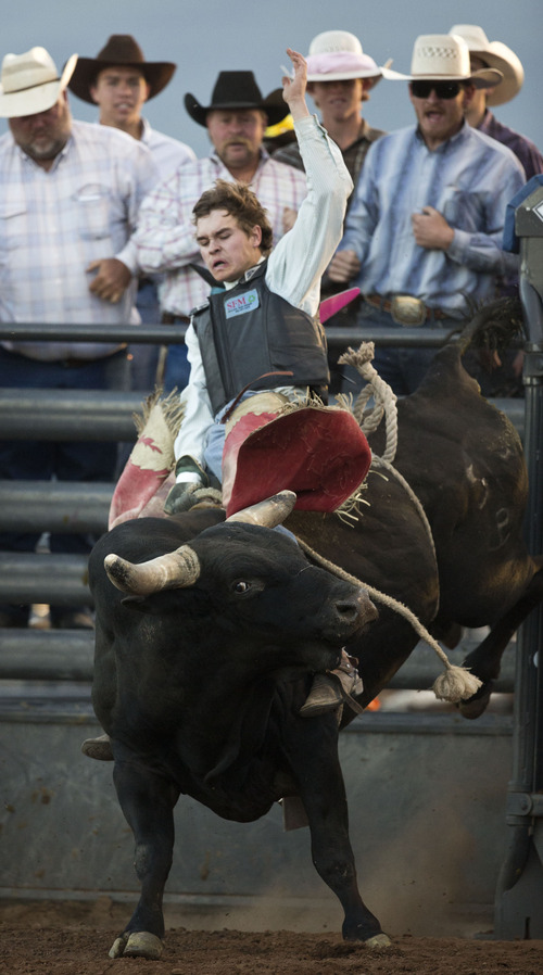 Lennie Mahler  |  The Salt Lake Tribune
Dakota Ogden scores a 74 in bull riding to win the event in the Utah High School Rodeo Championships in Heber City, Utah, Friday, June 14, 2013.