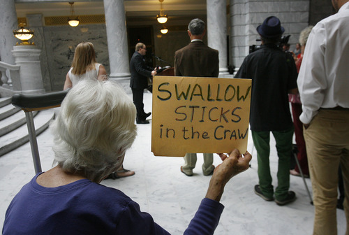 Scott Sommerdorf   |  The Salt Lake Tribune
Naomi Franklin of the League of Women Voters holds up a sign describing her views at a rally in the Capitol Rotunda showing solidarity to protest alleged corruption in the attorney general's office as House Republicans meet to discuss possible impeachment proceedings against John Swallow, Wednesday, June 19, 2013.