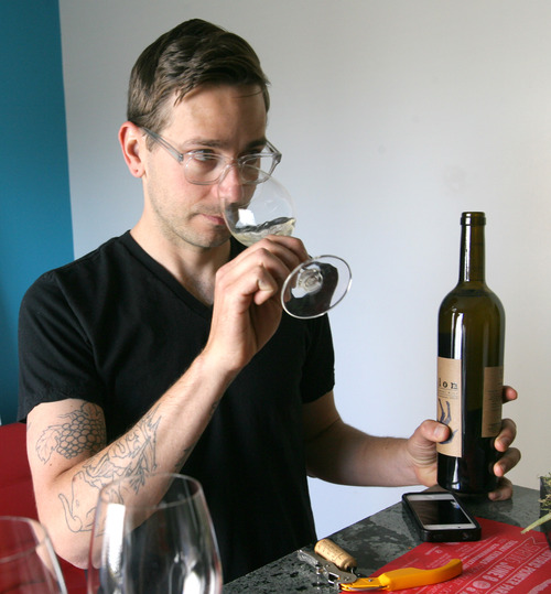 Rick Egan  | The Salt Lake Tribune 

Local wine maker, Evan Lewandowski
samples one of his wines. Grapes are from CA, but processing happens in Utah. He eventually wants to grow vineyard here in Utah. Thursday, June 13, 2013.