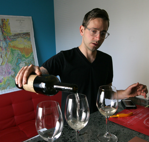 Rick Egan  | The Salt Lake Tribune 
Utah wine maker Evan Lewandowski pours a bottle of Mahlon wine. The grapes are from CA, but processing happens in Utah. He eventually wants to grow vineyard here in Utah. Thursday, June 13, 2013.