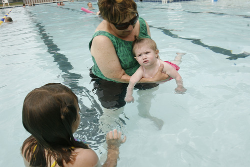 Scott Sommerdorf   |  The Salt Lake Tribune
Susan Major gives her 1 year old granddaughter Kyla Lillywhite some experience in the smaller pool at Layton Surf N'Swim. An examination of how much taxpayer money goes into city-funded water parks, such as Clearfield Aquatics Center and the Layton Surf N'Swim. Some say it's a bad use of public money, others say it's a civic duty.