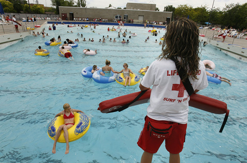 Scott Sommerdorf   |  The Salt Lake Tribune
As lifeguard Rae Gall watches, the public enjoys the wave pool at  Layton Surf N'Swim, Monday, June 10, 2013. An examination of how much taxpayer money goes into city-funded water parks, such as Clearfield Aquatics Center and the Layton Surf N'Swim. Some say it's a bad use of public money, others say it's a civic duty.