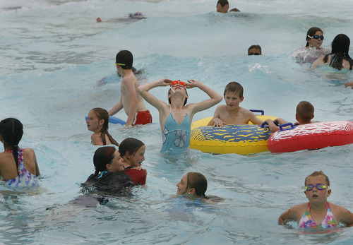 Scott Sommerdorf   |  The Salt Lake Tribune
The public enjoys the wave pool at  Layton Surf N'Swim, Monday, June 10, 2013. An examination of how much taxpayer money goes into city-funded water parks, such as Clearfield Aquatics Center and the Layton Surf N'Swim. Some say it's a bad use of public money, others say it's a civic duty.