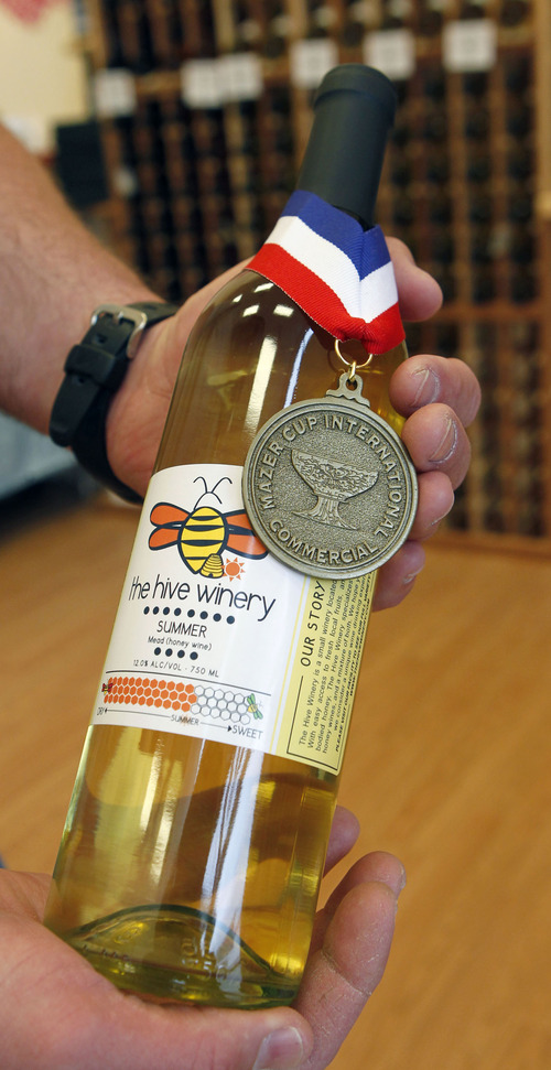 Al Hartmann  |  The Salt Lake Tribune
Jay Jayne holds a bottle of award winning Summer Mead (honey wine.)  The wines are starting to win national and international medals in their class despite only being in business for two years.  The Hive Winery is one of six Utah wineries which are facing hurdles put up by state lawmakers that make it difficult for them to do business.