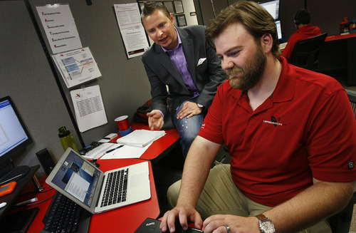 Scott Sommerdorf   |  The Salt Lake Tribune
President and CEO Spencer Ferguson, left, speaks with Field Technician Sean Beck as Beck works at his desk at Wasatch IT in Murray, which outsources services to business clients, and also sells computer hardware and software products to businesses, Friday, June 21, 2013.