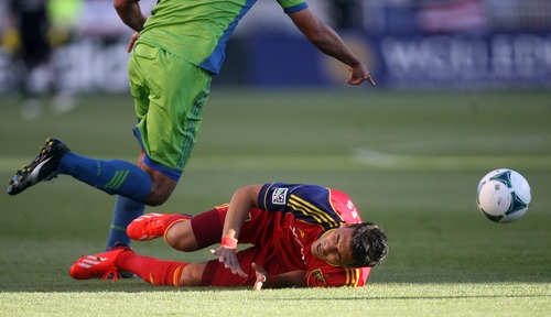 Kim Raff  |  The Salt Lake Tribune
(bottom) Real Salt Lake midfielder Javier Morales (11) reacts to being knocked onto the ground by (left) Seattle Sounders FC defender Leo Gonzalez (12) during the first half at Rio Tinto Stadium in Sandy on June 22, 2013. Real went on to win the game 2-0.