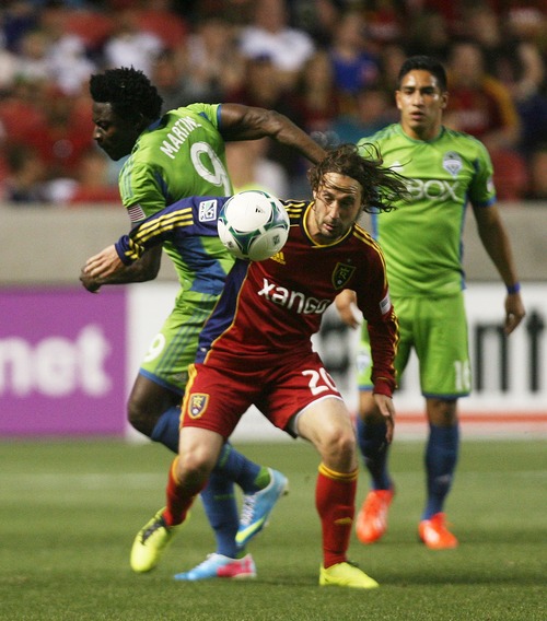 Kim Raff  |  The Salt Lake Tribune
(front) Real Salt Lake midfielder Ned Grabavoy (20) tries to hold back Seattle Sounders FC forward Obafemi Martins (9) from getting the ball during the second half at Rio Tinto Stadium in Sandy on June 22, 2013. Real went on to win the game 2-0.