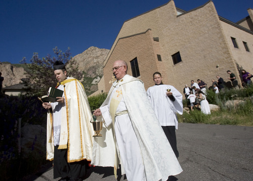Kim Raff  |  The Salt Lake Tribune
The Rev. Erik Richtsteig, left, leads parishioners in a procession around St. James the Just Catholic Church in Ogden during a Mass of Reparation ceremony on June 20, 2013. The ceremony was scheduled to cleanse the church after James Evans was allegedly shot by his son-in-law Charles Richard Jennings Jr. during Mass on Sunday. Richtsteig led a procession around the building and sanctuary while reciting prayers to cleanse the building.