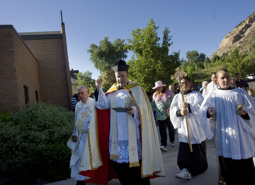 Kim Raff  |  The Salt Lake Tribune
The Rev. Erik Richtsteig, center, leads parishioners in a procession around St. James the Just Catholic Church iThe ceremony was scheduled to cleanse the church after James Evans was allegedly shot by his son-in-law Charles Richard Jennings Jr. during Mass on Sunday. Richtsteig led a procession around the building and sanctuary while reciting prayers to cleanse the building.