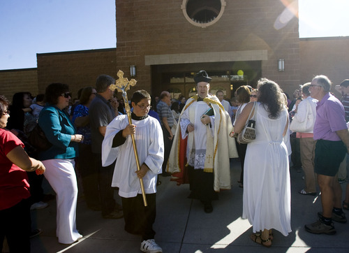 Kim Raff  |  The Salt Lake Tribune
The Rev. Erik Richtsteig, center, gathers parishioners outside St. James the Just Catholic Church in Ogden to begin a Mass of Reparation ceremony on June 20, 2013.  The ceremony was scheduled to cleanse the church after James Evans was allegedly shot by his son-in-law Charles Richard Jennings Jr. during Mass on Sunday. Richtsteig led a procession around the building and sanctuary while reciting prayers to cleanse the building.