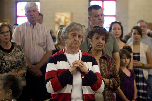 Kim Raff  |  The Salt Lake Tribune
Kathy Phillips, center, watches as (not pictured) the Rev. Erik Richtsteig leads a procession around St. James the Just Catholic Church in Ogden during a Mass of Reparation ceremony on June 20, 2013.  The ceremony was scheduled to cleanse the church after James Evans was allegedly shot by his son-in-law Charles Richard Jennings Jr. during Mass on Sunday.