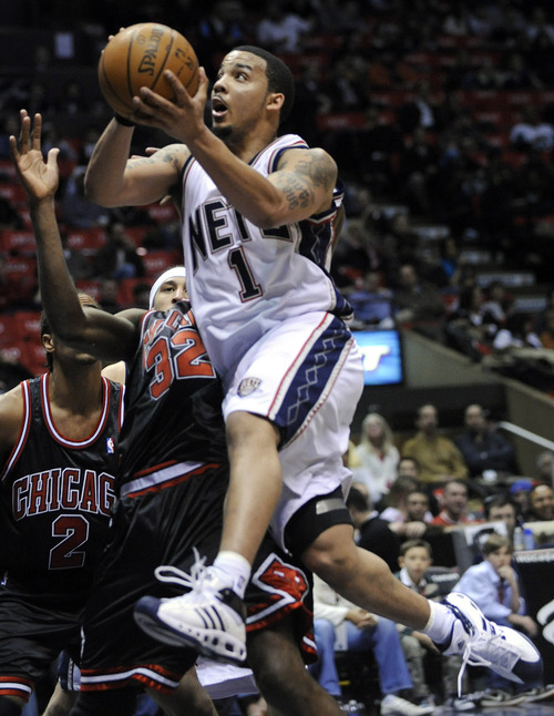 New Jersey Nets' Marcus Williams drives to the basket as he is guarded by Chicago Bulls' Joe Smith (32) during the second quarter of NBA basketball Wednesday night, Feb. 20, 2008 in East Rutherford, N.J. (AP Photo/Bill Kostroun)