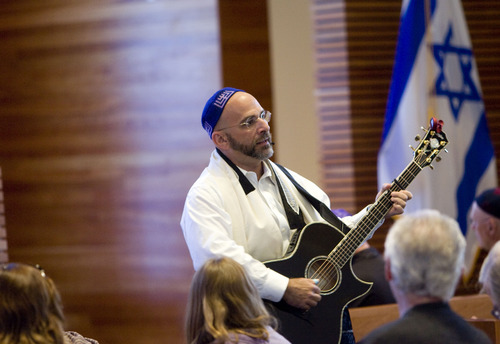 Kim Raff  |  The Salt Lake Tribune
Rabbi Joshua Aaronson leads the congregation in a song during Shabbat service at Temple Har Shalom in Park City on May 31, 2013. Rabbi Aaronson will be leaving the congregation at the end of the month.