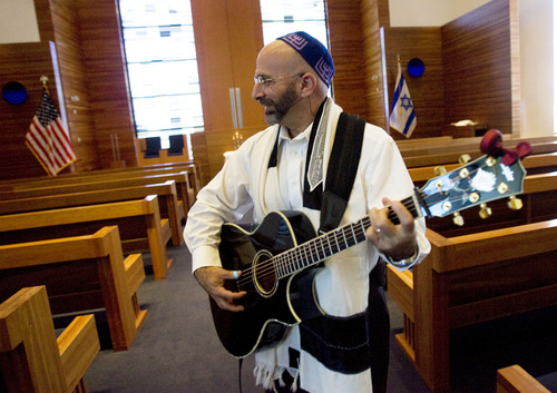 Kim Raff  |  The Salt Lake Tribune
Rabbi Joshua Aaronson plays guitar as people arrive for a Shabbat service at Temple Har Shalom in Park City on May 31, 2013.  Rabbi Aaronson will be leaving the congregation at the end of the month.
