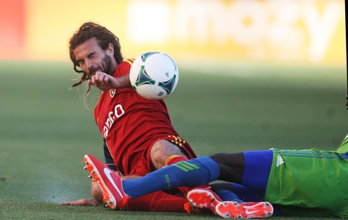 Kim Raff  |  The Salt Lake Tribune
(back) Real Salt Lake midfielder Kyle Beckerman (5) collides with (right) Seattle Sounders FC defender Djimi Traore (19) during the first half of a game at Rio Tinto Stadium in Sandy on June 22, 2013. Beckerman went on to score the first goal of the game late in the first half.
