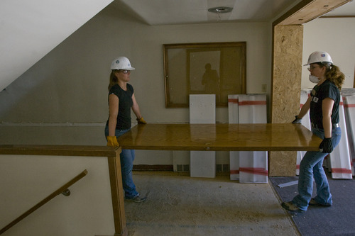 Rick Egan  | The Salt Lake Tribune 

Mindy Osmond, and and Paula Thornock, volunteers from OC Tanner, are remove a door from the old LDS church on 400 East and 100 South in Salt Lake, Wednesday, June 26, 2013. The American Cancer Society has donated a retired LDS Church building to Habitat for Humanity, which will eventually be a Hope Lodge for cancer patients.