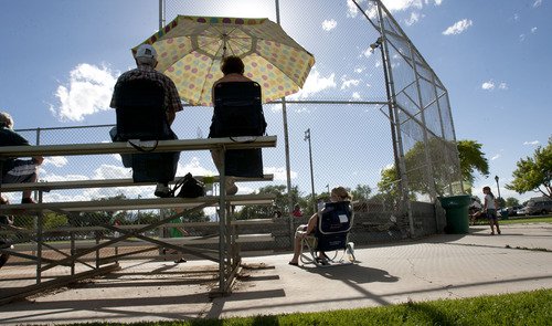 Steve Griffin | The Salt Lake Tribune


Fans block the sun with an umbrella as they watch little league baseball at the Riverton baseball fields near 12800 south and 1500 west in Riverton, Utah Tuesday June 25, 2013.