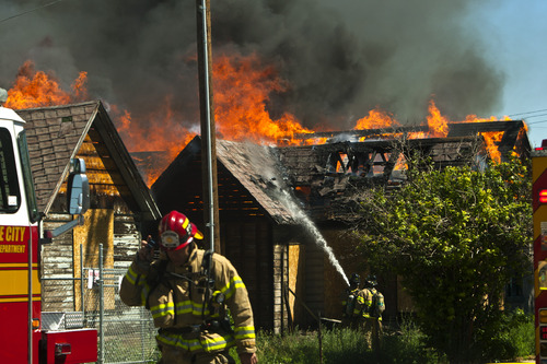 Chris Detrick  |  The Salt Lake Tribune
Salt Lake City firefighters work at dousing two abandoned homes that are on fire near 950 South 400 West Thursday June 27, 2013.