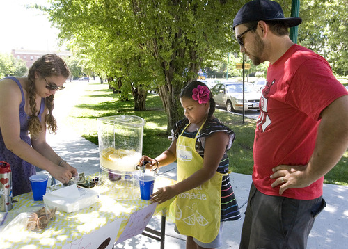 Paul Fraughton  |  The Salt Lake Tribune
Parker Ellison stops for a cold lemonade at Maya Johnson's, age 9, and Chelsea Hoyt's lemonade and cookie stand on the corner of South Temple and University Street.                    
 Thursday, June 27, 2013