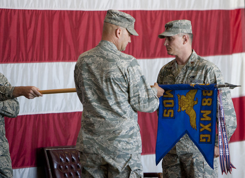 Steve Griffin | The Salt Lake Tribune
Maj. Jason Ross, 388th Maintenance Operations Squadron commander, right, watches as Col. Dane P. West furls the flag symbolizing the official close of the squadron during a deactivation ceremony in Ogden Friday June 28, 2013. The squadron is the smallest of its kind in the Air Force, with just 150 people, and was chosen to be inactivated a year ago as part of an Air Force-wide restructuring initiative. The idea is to better allocate company and field grade officers to needed positions.