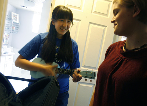 Scott Sommerdorf   |  The Salt Lake Tribune
Maryam Shehab, left, strums the ukulele that she is packing for her return trip to Kuwait, Wednesday, June 12, 2013. Shehab learned to play it during her stay in Utah while she lived with Highland High School student Brianna Lewis's family. Lewis, right, is one of 65 American students selected this year for the Kennedy-Lugar Youth Exchange and Study (YES) Program, which exchanges students with about a dozen Muslim countries worldwide to foster positive relationships. Lewis will leave Utah later this month to spend her junior year in India.
