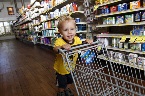 Al Hartmann  |  The Salt Lake Tribune
Kai Vogtli, 2, shopping with his mother, Jillian Vogtli, of nearby Hoytsville runs the floor of Summit Merc on Coalville's Main Street. The traditional small town general store carries everything you need. The 105-year-old store has been passed down through the Blonquist family for generations. It has wooden floors, a full grocery section with a white butcher cooler with hand cut meats, hardware section with farm equipment, and work clothes and boots.