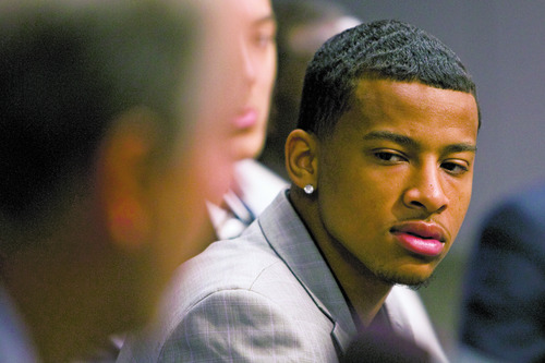 Rick Egan  | The Salt Lake Tribune 

Trey Burke (right) listens to Randy Rigby, during the press conference at the Jazz practice facility,  Friday, June 28, 2013.