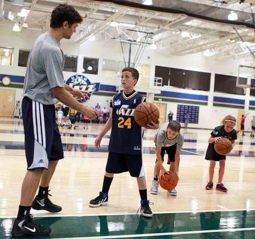 Michael Brandy  |  Special to the Tribune
Raul Neto (Utah Jazz guard) works with Trevor Steadman and other Junior Jazz kids from Farmington, Utah during  a basketball clinic by the Utah Jazz draft picks (Trey Burke, Rudy Gobert and Raul Neto) at Zions Bank Basketball Center.