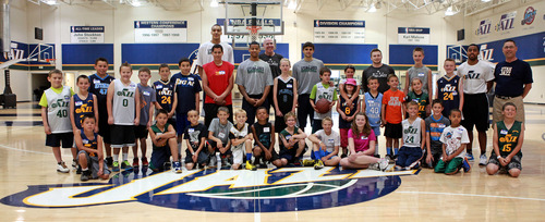 Michael Brandy  |  Special to the Tribune
Utah Jazz draft picks (Trey Burke, Rudy Gobert and Raul Neto and Jazz coaching staff) pose with Junior Jazz players from Farmington during a basketball clinic at Zions Bank Basketball Center.