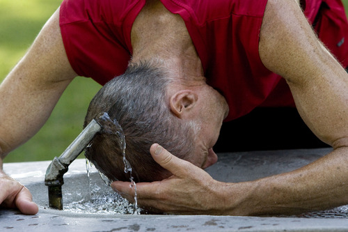Kim Raff  |  The Salt Lake Tribune
After a run, Andy Colbert cools down in the natural spring fountain at Liberty Park in Salt Lake City on June 29, 2013. Utah is in the middle of a record breaking heat wave with no cool weather relief in sight.