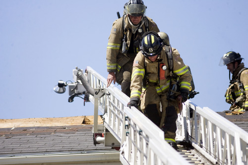 Kim Raff  |  The Salt Lake Tribune
Salt Lake City firefighters works to put out a fire in an apartment building at the Park City Apartments off of 900 West in Salt Lake City on June 30, 2013.