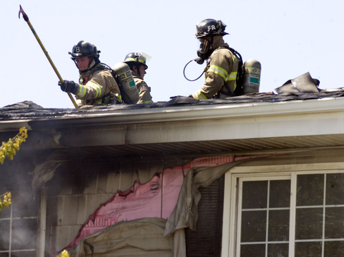 Kim Raff  |  The Salt Lake Tribune
Salt Lake City firefighters works to put out a fire in an apartment building at the Park City Apartments off of 900 West in Salt Lake City on June 30, 2013.