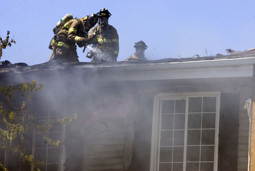 Kim Raff  |  The Salt Lake Tribune
Salt Lake City firefighters work to put out a fire in an apartment building at the Park City Apartments off of 900 West in Salt Lake City on June 30, 2013.